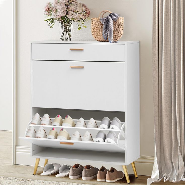 a white shoe rack with several pairs of shoes