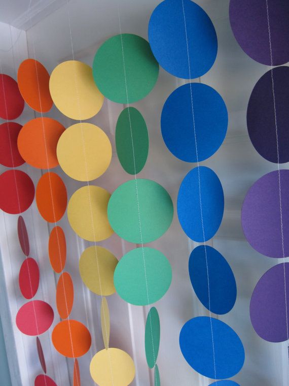 there are many different colored circles hanging on the wall