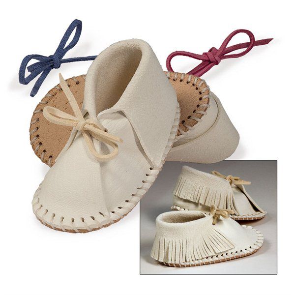 two pairs of baby moccales with bows on the top and bottom, one in white