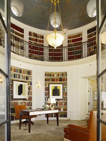 a living room filled with lots of books