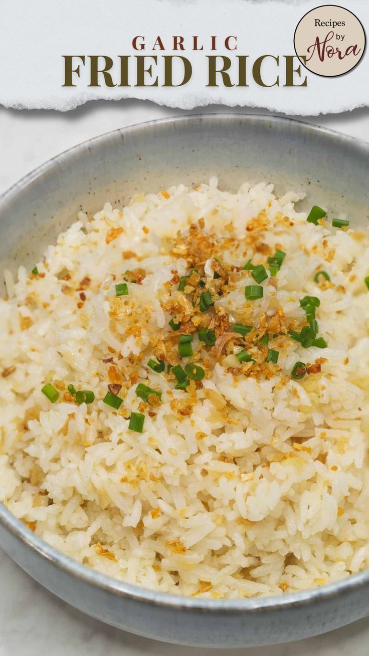 a bowl filled with rice on top of a white tablecloth next to a sign that says garlic fried rice