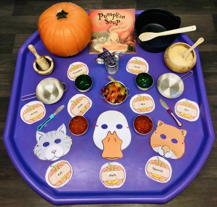 a purple tray topped with lots of different foods and condiments on top of it