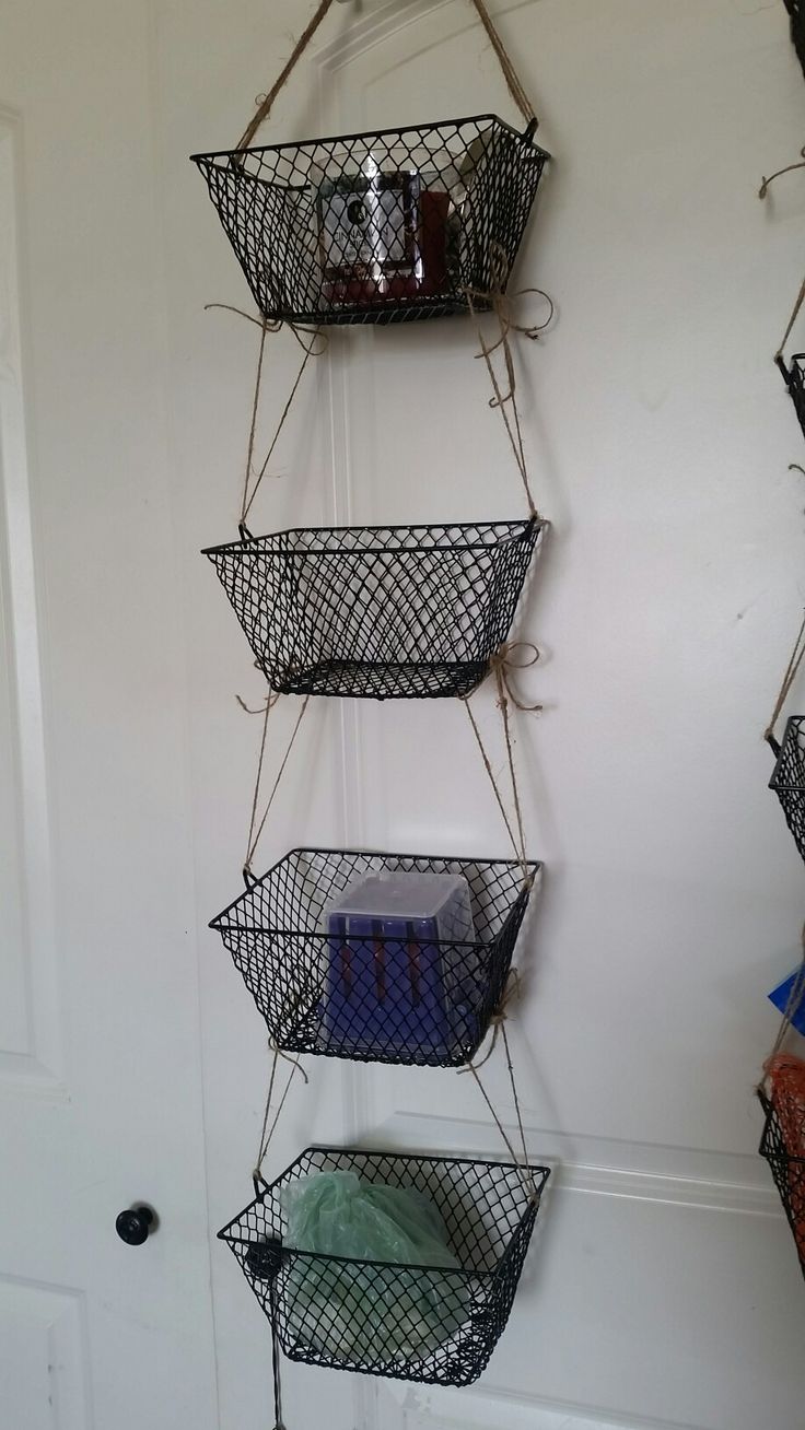 three metal baskets hanging on the wall