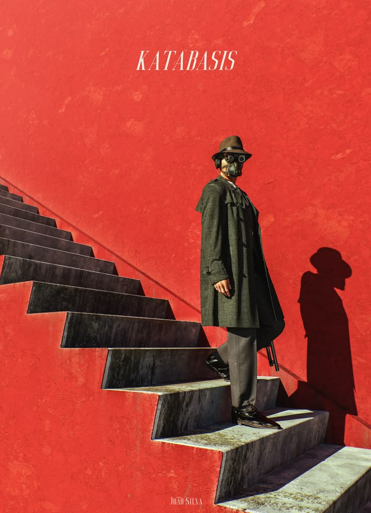 a man standing on top of steps next to a red wall with the words atabass