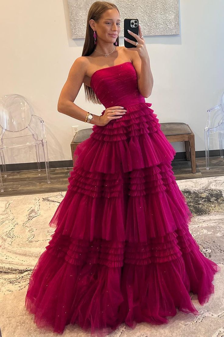 Rock this Peri-pleated, strapless tulle frock featuring tiers of ruffles, a built-in bra, and a zip-up back. Your full-length, dreamy-hued dress is perfect for a night of fun! Red Pink Prom Dress, Strapless Party Ball Gown With Ruffles, Strapless Ball Gown With Ruffles For Party, Strapless Ruffled Evening Dress For Prom, Strapless Tulle Evening Dress, Gala Strapless Tulle Dress With Ruched Bodice, Tiered Tulle Gown For Gala, Tiered Tulle Gown For Debutante Ball, Luxury Strapless Tulle Dress With Ruched Bodice For Gala