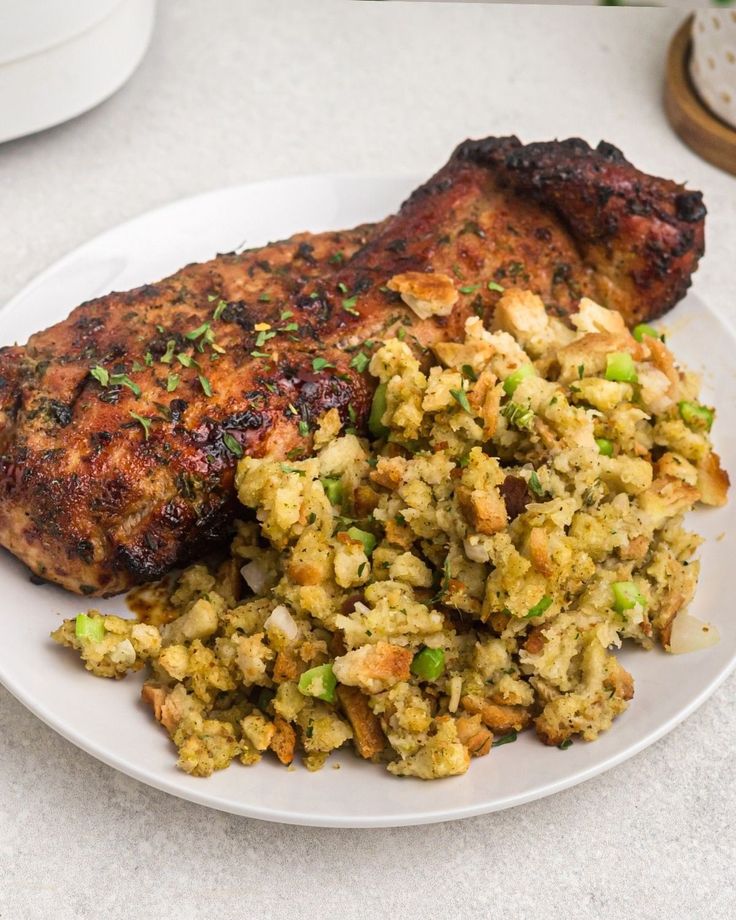 a white plate topped with meat and vegetables