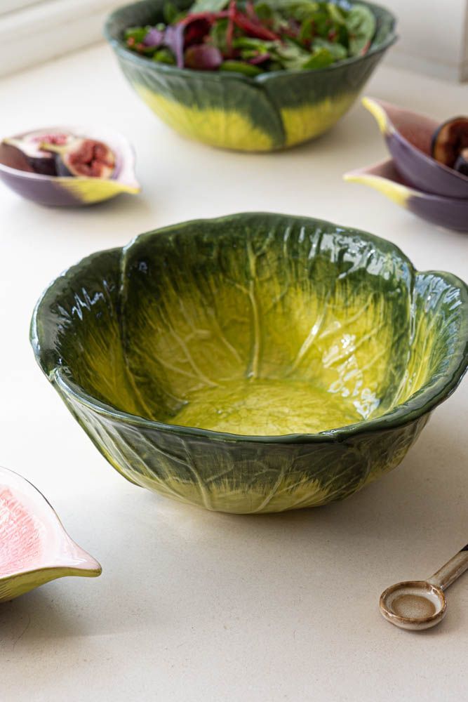 three bowls with different types of food in them sitting on a table next to utensils