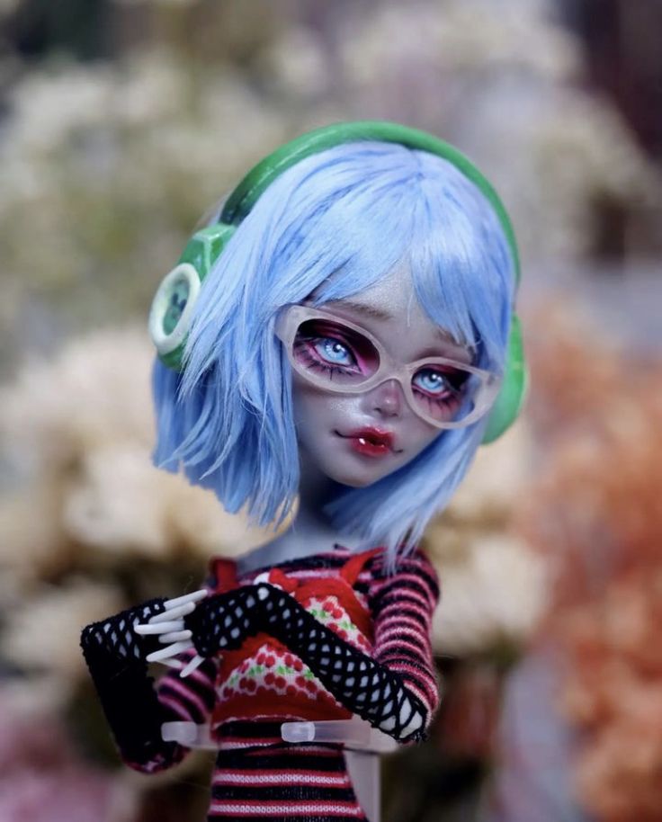 a close up of a doll with blue hair