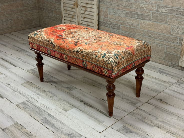 an ottoman sitting on top of a wooden floor