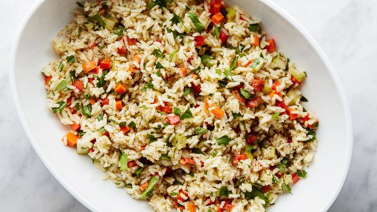 a white bowl filled with rice and vegetables