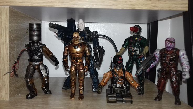 five action figures are posed on a shelf