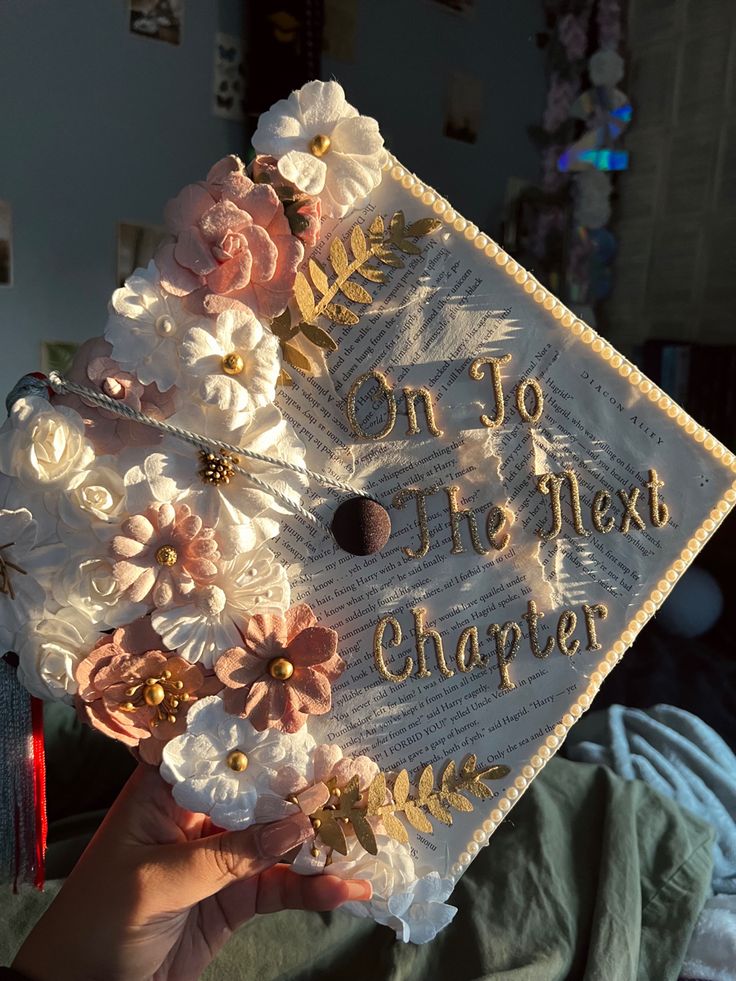 someone is holding up a graduation cap with flowers on it that says, on jo go the next charter