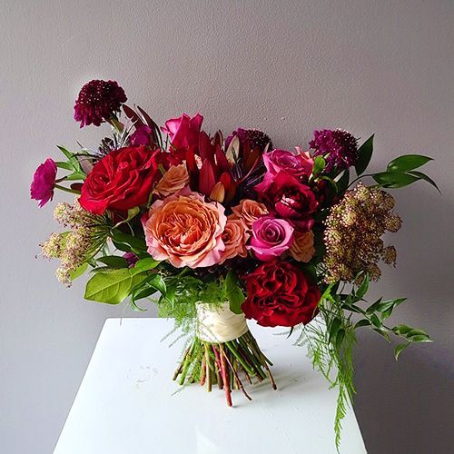 a bouquet of flowers sitting on top of a white table