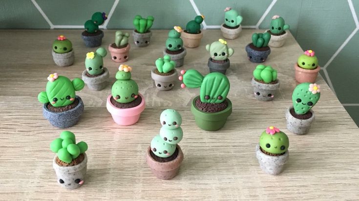 there are many small cactus plants in the potted planters on the table together