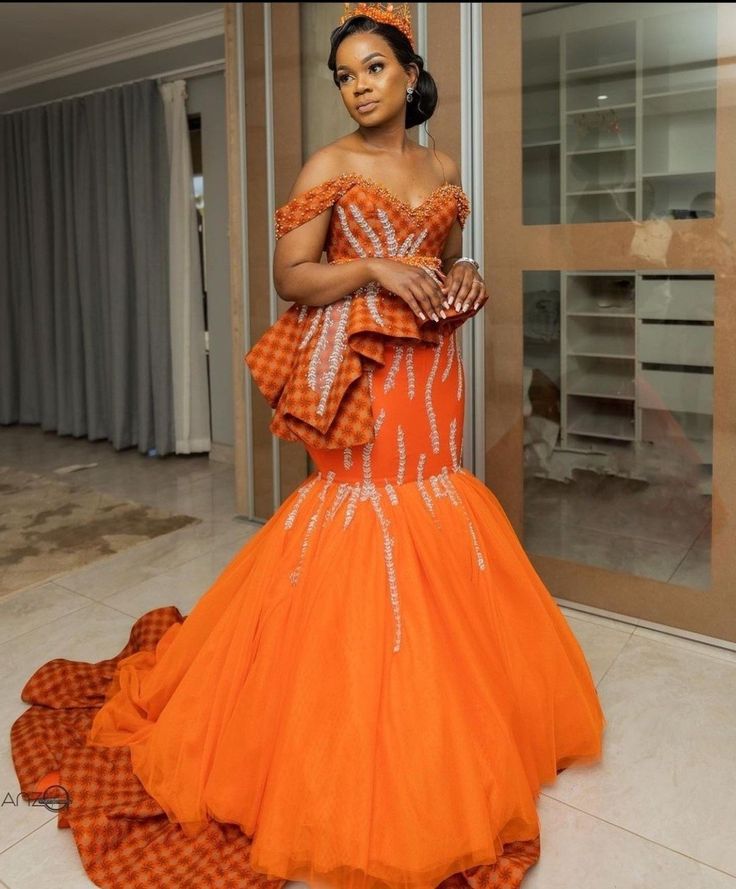 a woman in an orange and white gown