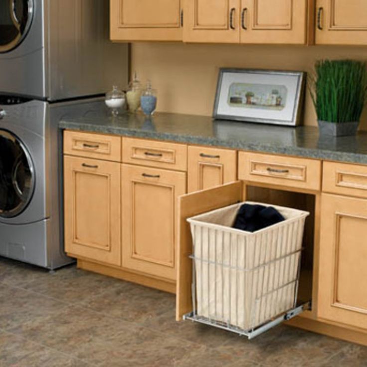 a kitchen with wooden cabinets and white baskets