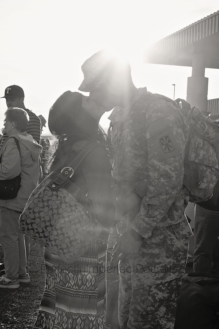 two soldiers kissing each other in front of people