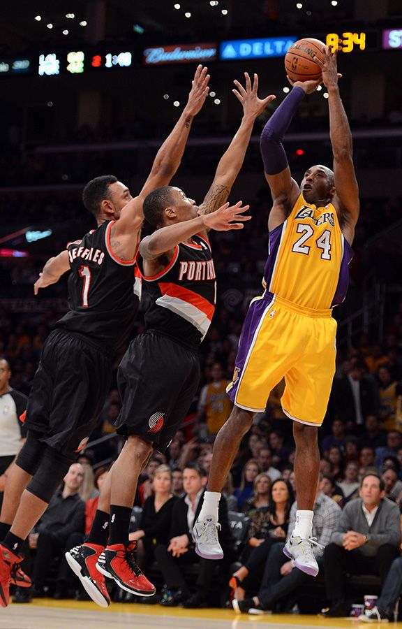 the basketball players are trying to block the ball from going up for it in the air