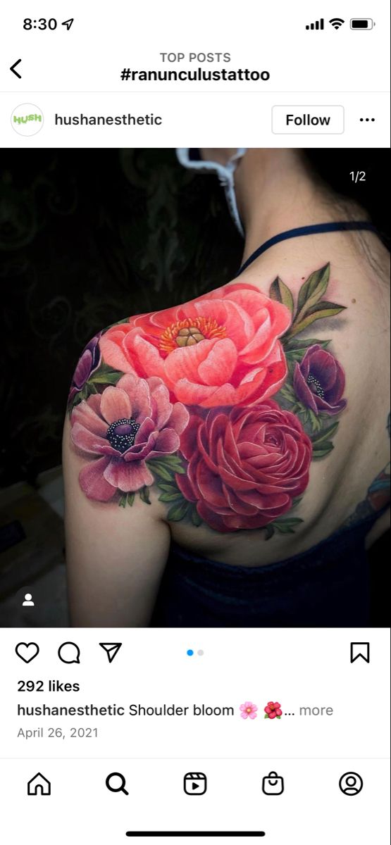 the back of a woman's shoulder with pink flowers on it and green leaves