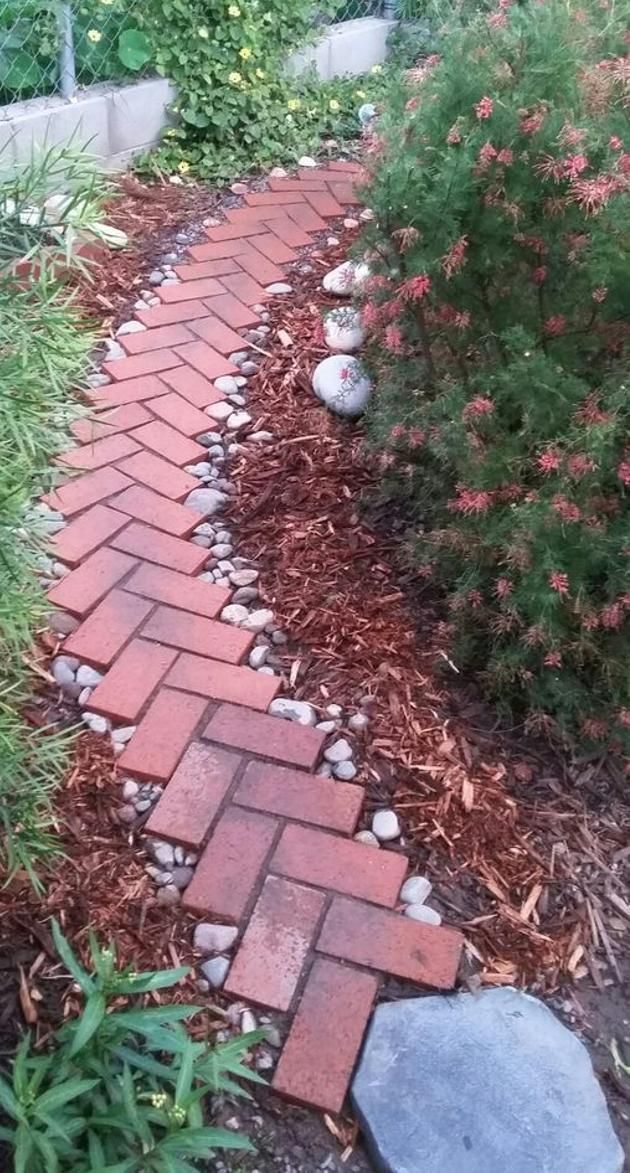 a brick path in the middle of a garden