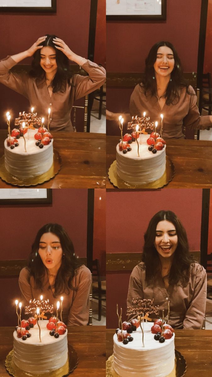 a woman sitting in front of a cake with candles on it