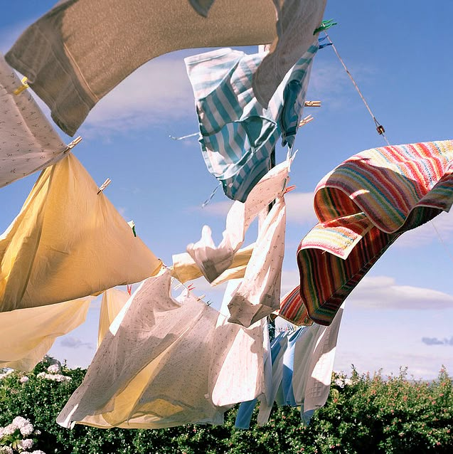 many different colored cloths hanging in the air