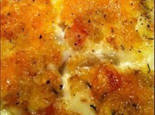 a close up view of some food with cheese and other toppings on it's surface