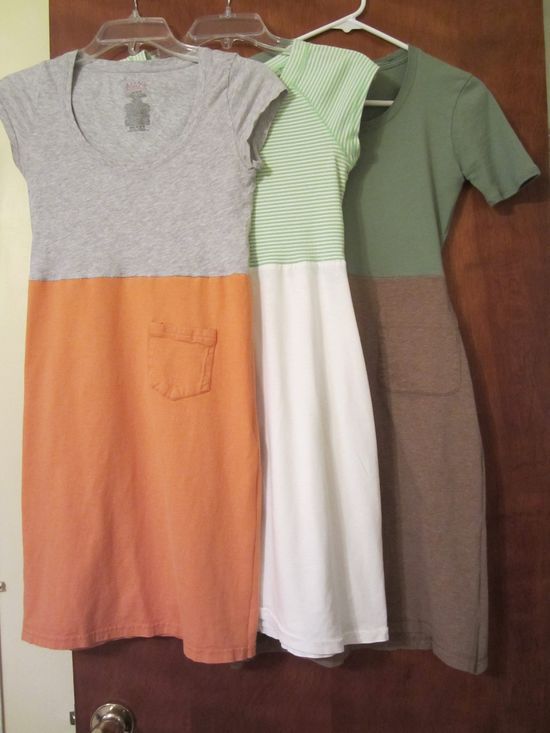 three different colored shirts hanging on a clothes rack