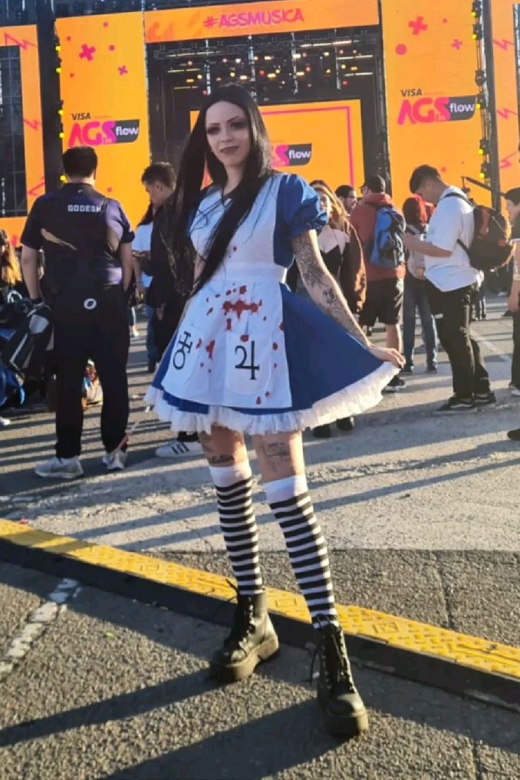 a woman dressed as a zombie is standing on the street with her hands in her pockets