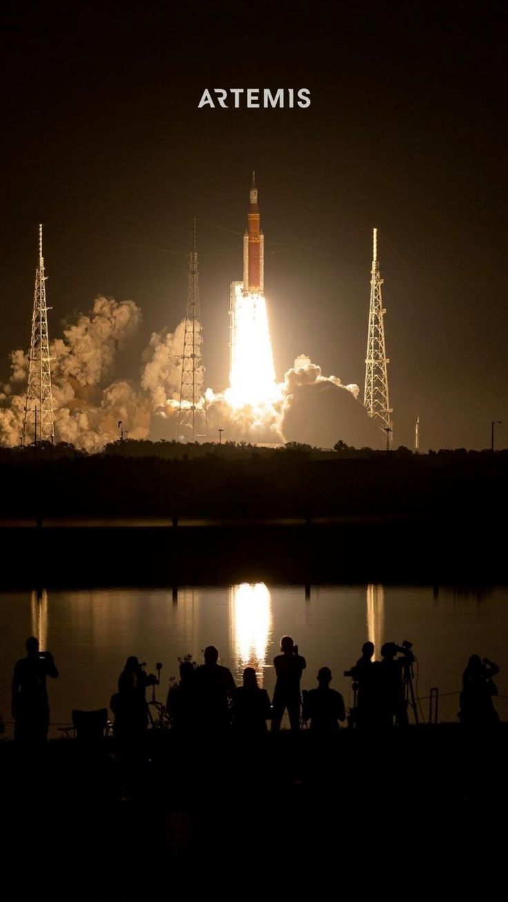 the space shuttle lifts off into the night sky