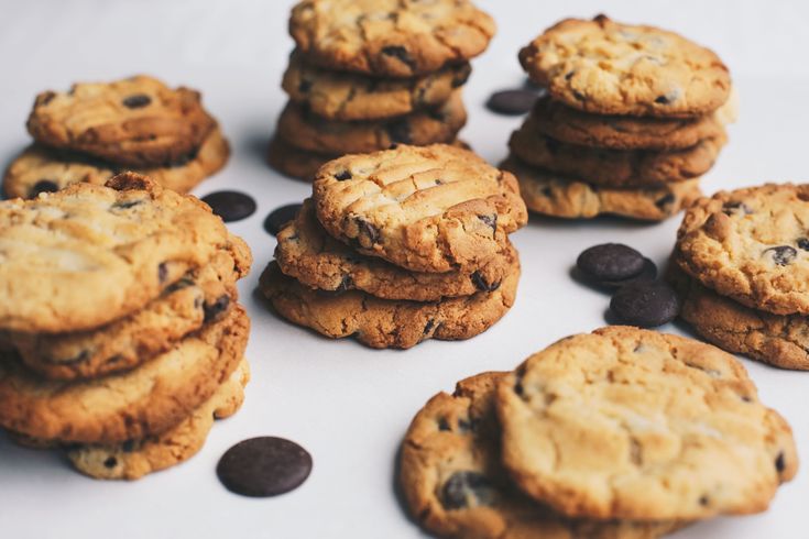 chocolate chip cookies are arranged on a table