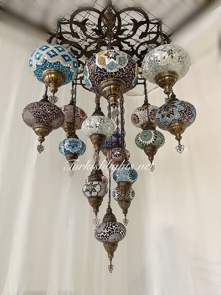 a chandelier hanging from the ceiling with many different colored glass balls on it