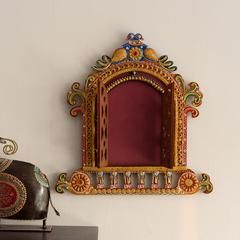 an ornate mirror on the wall next to a vase and other decorative items in front of it