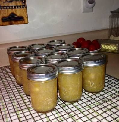 several jars filled with pickles sitting on top of a counter