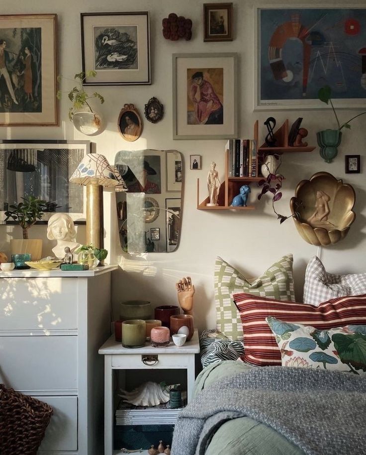 a bedroom with many pictures on the wall