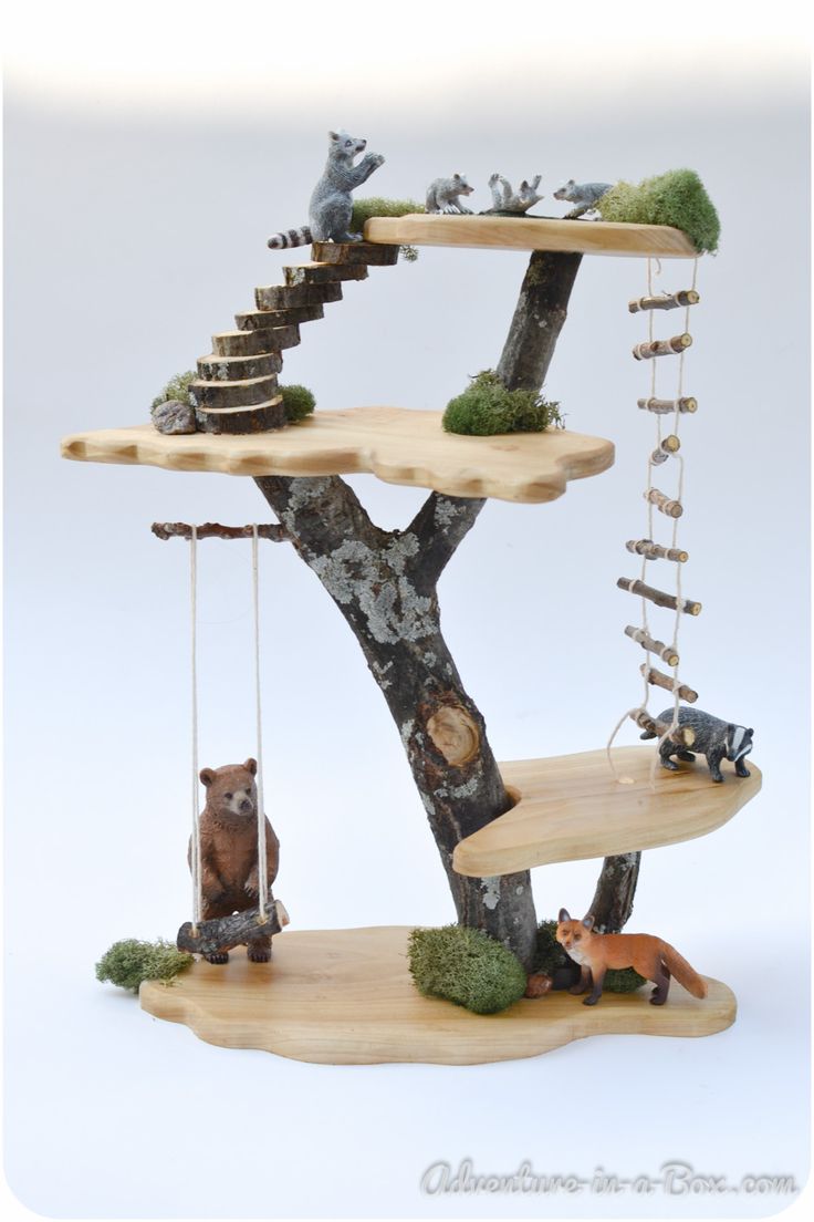 a miniature tree house with animals on it