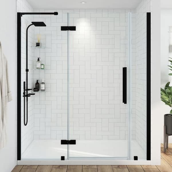 a bathroom with white tile and black trim on the shower door, wood flooring