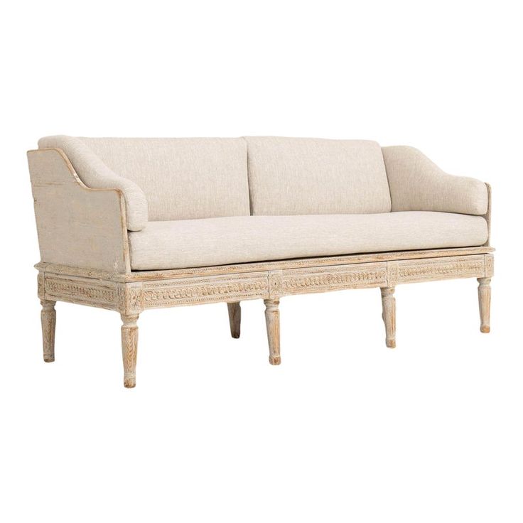 a white couch sitting on top of a wooden frame