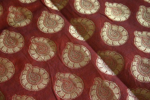 a red and gold fabric with circles on it