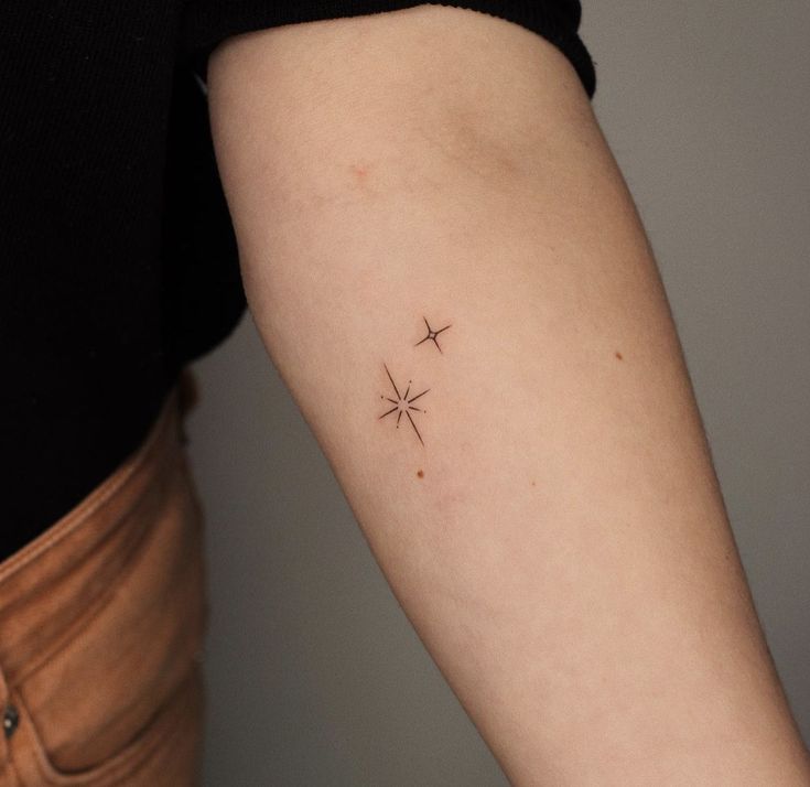 a small star tattoo on the left arm