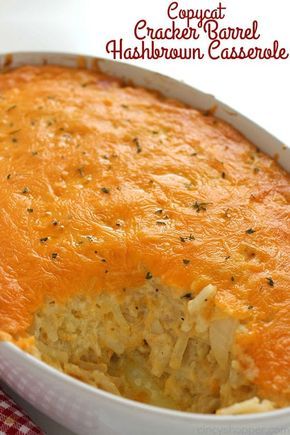 a casserole dish with cheese and other toppings in a white bowl on a red checkered cloth