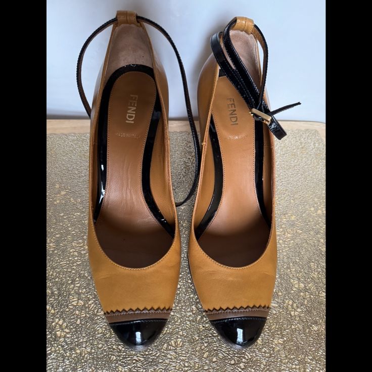 Elevate Your Style With These Stunning Fendi Dcollet Vernice High Heels In Size 38. Crafted With High-Quality Leather, These Strappy Brown Heels Are Perfect For Any Occasion. The Elegant And Sleek Design Is Complemented By The Fendi Brand, Adding A Touch Of Luxury To Your Wardrobe. These Heels Are Perfect For The Modern Woman Who Wants To Add A Touch Of Sophistication To Her Look. With A Us Shoe Size Of 8, They Are Suitable For Women Of All Ages. Order Now And Take Your Fashion Game To The Next Level. Excellent Condition. With Sole Protection. Worn Only Once. Designer Brown High Heel Shoes, Designer Brown High Heels, Brown Heels With Contrasting Heel Counter For Evening, Designer Brown Heels With Almond Toe, Designer Brown Heels For Office, Designer Brown Patent Leather Heels, Formal Brown Heels With Contrasting Heel Counter, Formal Brown Heels With Contrasting Heel, Brown Court Shoes With Heel Strap For Formal Occasions