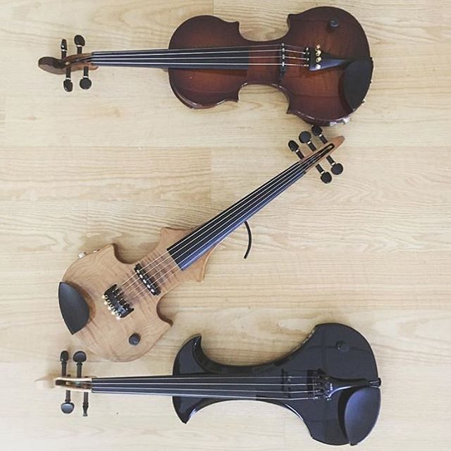 two violin's are laying on the floor next to each other