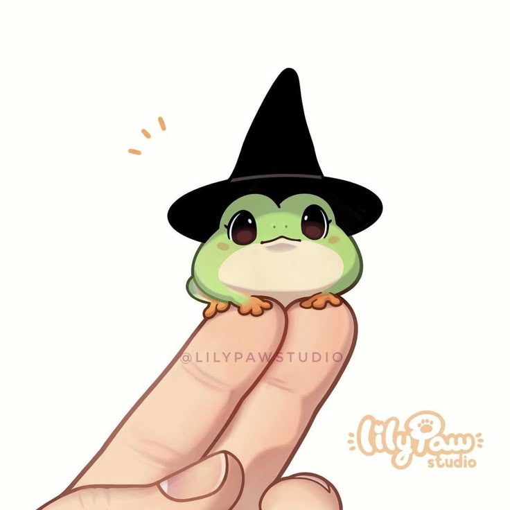 a hand holding a small green frog wearing a black hat and sitting on it's thumb