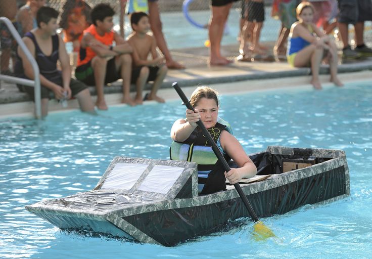 a woman in a black life jacket paddling a boat