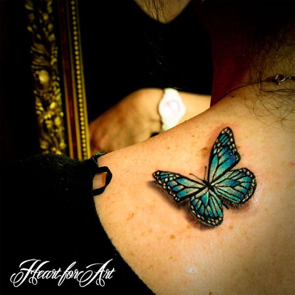 a woman with a blue butterfly tattoo on her shoulder