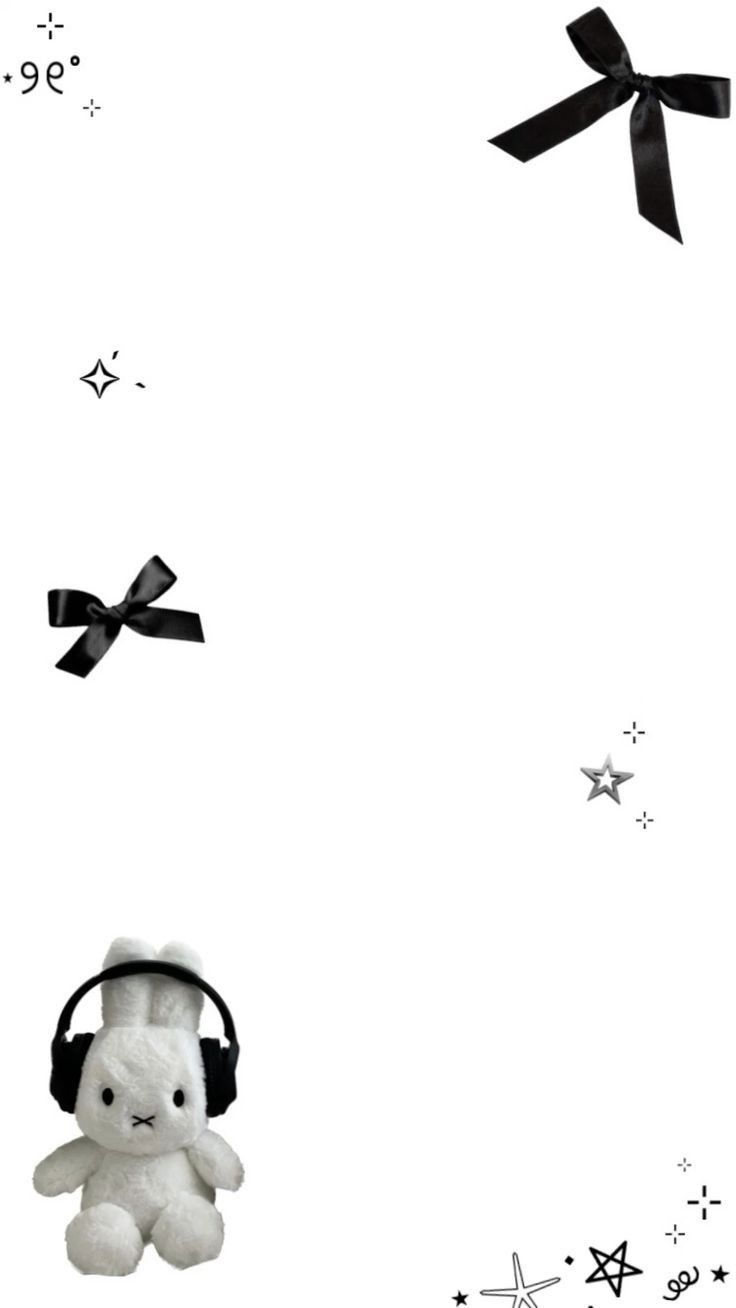 a white teddy bear with headphones on its ears is in front of some black and white stars