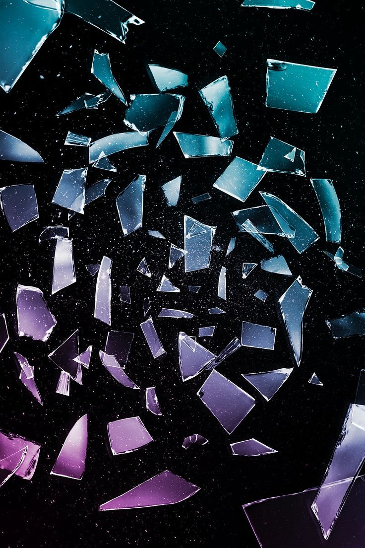 many pieces of broken glass are shown in this image, and the background is black