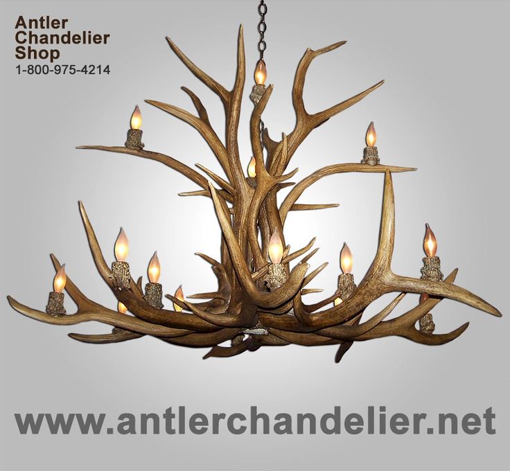 an antler chandelier with candles in it