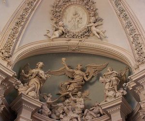 an ornately decorated ceiling with statues and angels